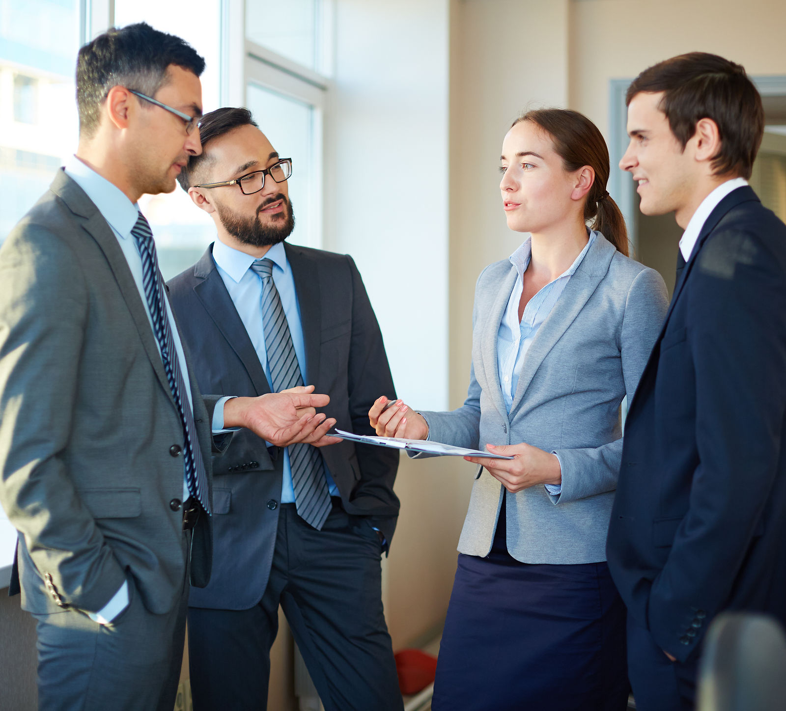 Employees reviewing values and standards on a clipboard